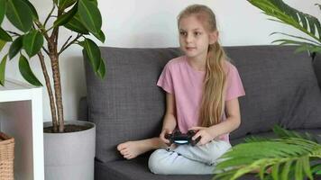 Little girl playing internet video game using remote controller
