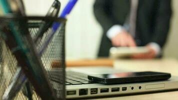 Businessman touching and using tablet computer in office, businessman using tablet computer while standing in office, selective focus video