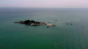 Aerial view small island Pulau Tikus with rock video