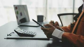 Financial analysts analyze business financial reports on a digital tablet planning investment project during a discussion at a meeting of corporate showing the results of their successful teamwork. video