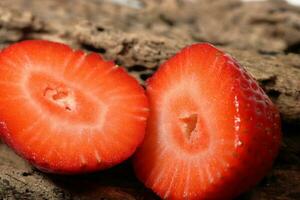 Fresh strawberry half slice in close up view. Macro photo