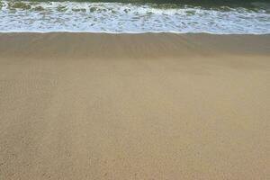 Waves on shore of tropical beautiful sand beach on a sunny day photo