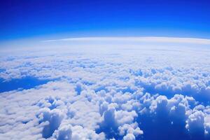 View of the sky above clouds over the earth deep blue sky with white clouds. photo