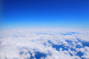 View of the sky above clouds over the earth deep blue sky with white clouds. photo