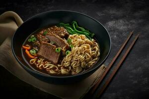 Spicy red soup beef noodle in a bowl on wooden table photo