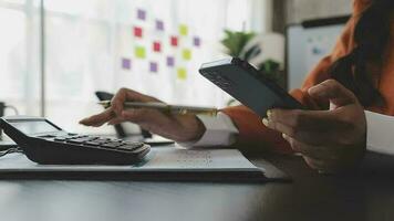 Financial analysts analyze business financial reports on a digital tablet planning investment project during a discussion at a meeting of corporate showing the results of their successful teamwork. video