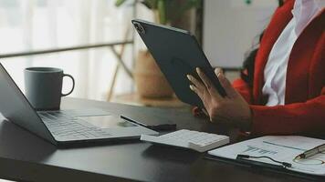 Financial analysts analyze business financial reports on a digital tablet planning investment project during a discussion at a meeting of corporate showing the results of their successful teamwork. video