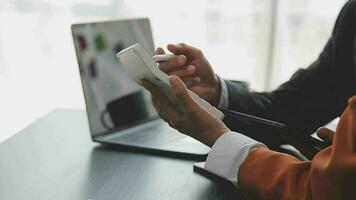 Financial analysts analyze business financial reports on a digital tablet planning investment project during a discussion at a meeting of corporate showing the results of their successful teamwork. video