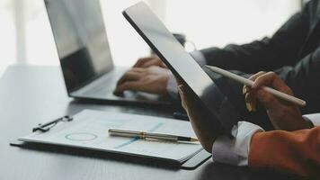 Financial analysts analyze business financial reports on a digital tablet planning investment project during a discussion at a meeting of corporate showing the results of their successful teamwork. video