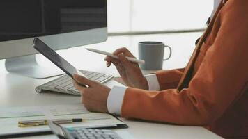 Financial analysts analyze business financial reports on a digital tablet planning investment project during a discussion at a meeting of corporate showing the results of their successful teamwork. video