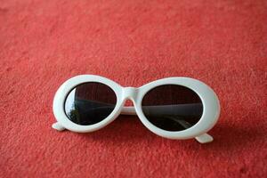 White Children Eyeglass with red background photo