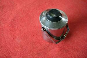 silver stainless teapot with red background photo