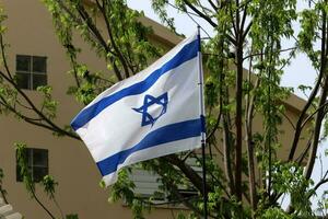 The blue and white flag of Israel with the six-pointed Star of David. photo