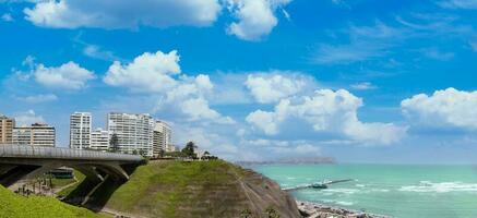 Peru, Lima, scenic ocean view and Miraflores Malecon promenade with shopping malls cafes and restaurants photo