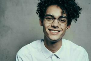 handsome man with glasses curly hair fashion self confidence photo