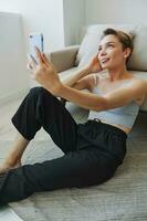 Woman blogger selfies on phone, selfies and online conversations for followers, teenager develops social media, freelancer from home photo