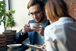 young couple work colleagues professional communication in a cafe photo