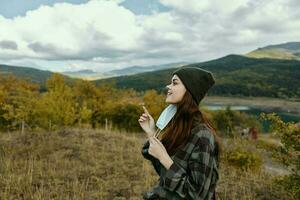 Woman in warm clothes outdoors in autumn with a mask on her face photo