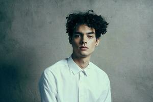 guy with curly hair in a white shirt curly hair emotions official photo