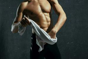 man with a pumped-up torso towels in his hands and workout motivation model photo