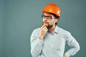 Cheerful man in orange hard hat shirt gesturing with hands work construction engineer photo