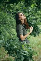 Woman outdoors Green branch enjoying nature trees photo