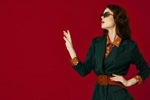 beautiful brunette in glamor suit studio red background photo