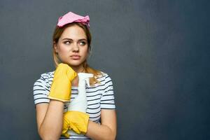 Cleaning lady with detergent pink rag service lifestyle cropped view photo