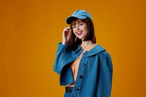 Beautiful fashionable girl denim cap red lips glamor fashion yellow background unaltered photo