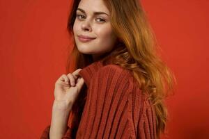 woman in red sweater fixing studio fashion lifestyle photo