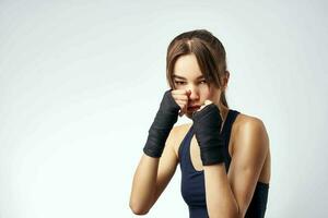 sportive woman with bandaged hands boxing exercise workout photo