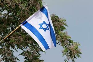The blue and white flag of Israel with the six-pointed Star of David. photo