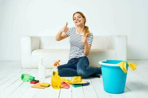 Cleaning lady with bucket of washing supplies on the floor interior housework photo