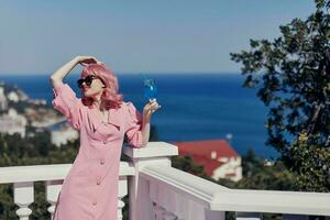 glamorous woman drinking a cocktail on the terrace Relaxation concept photo