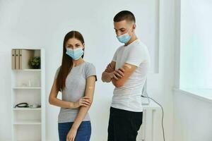 man and woman with bactericidal patches on their hands in the hospital immunity health covid-19 passport photo