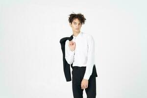 guy in a jacket shirt and trousers on a light background curly hair cropped view model photo