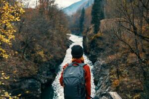 woman hiker backpack mountains river fresh air photo