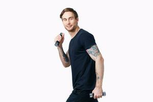 sporty man with dumbbells on white background her tattoo on arm black t-shirt cropped view photo