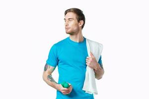 man in blue t-shirt towel on shoulder cropped view color background fitness photo