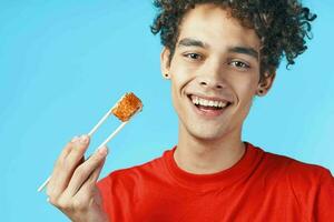 man in red t-shirt curly hair dry snack japanese fast food photo