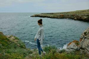 portrait of a woman sweaters cloudy sea admiring nature female relaxing photo