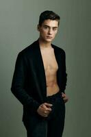Handsome man black jacket nude torso modern style self-confidence photo