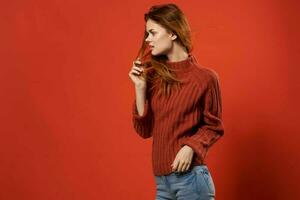 woman in red sweater lifestyle glamor cosmetics red background photo