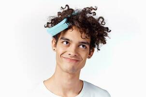 man combing curly hair dissatisfaction emotions close-up photo