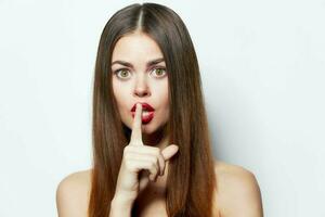 Woman finger near lips Top secret portrait spa treatments photo