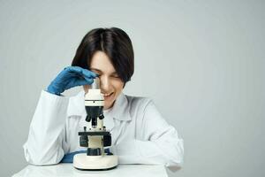woman laboratory assistant microscope biology research science photo