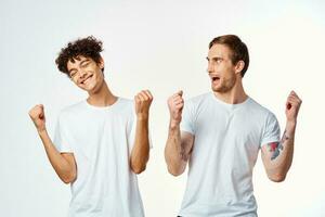 two men in white t-shirts are standing next to friendship emotions photo