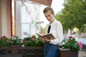 student with a book in his hands outdoors in a summer cafe rest Lifestyle photo