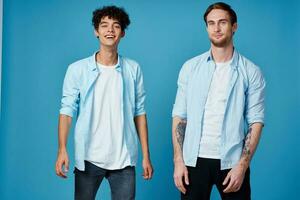 friends in unbuttoned shirts and white t-shirts jeans blue background fun communication party photo