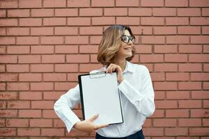 woman in white shirt documents work professional photo